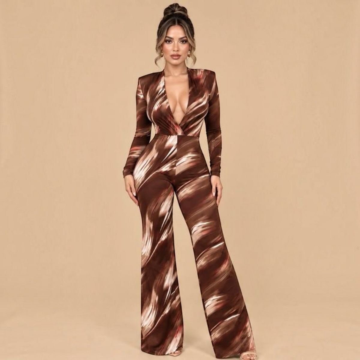 Angie Style Boutique slim fit brown printed jumpsuit with long sleeves, shoulder pads, and a deep V-neckline.