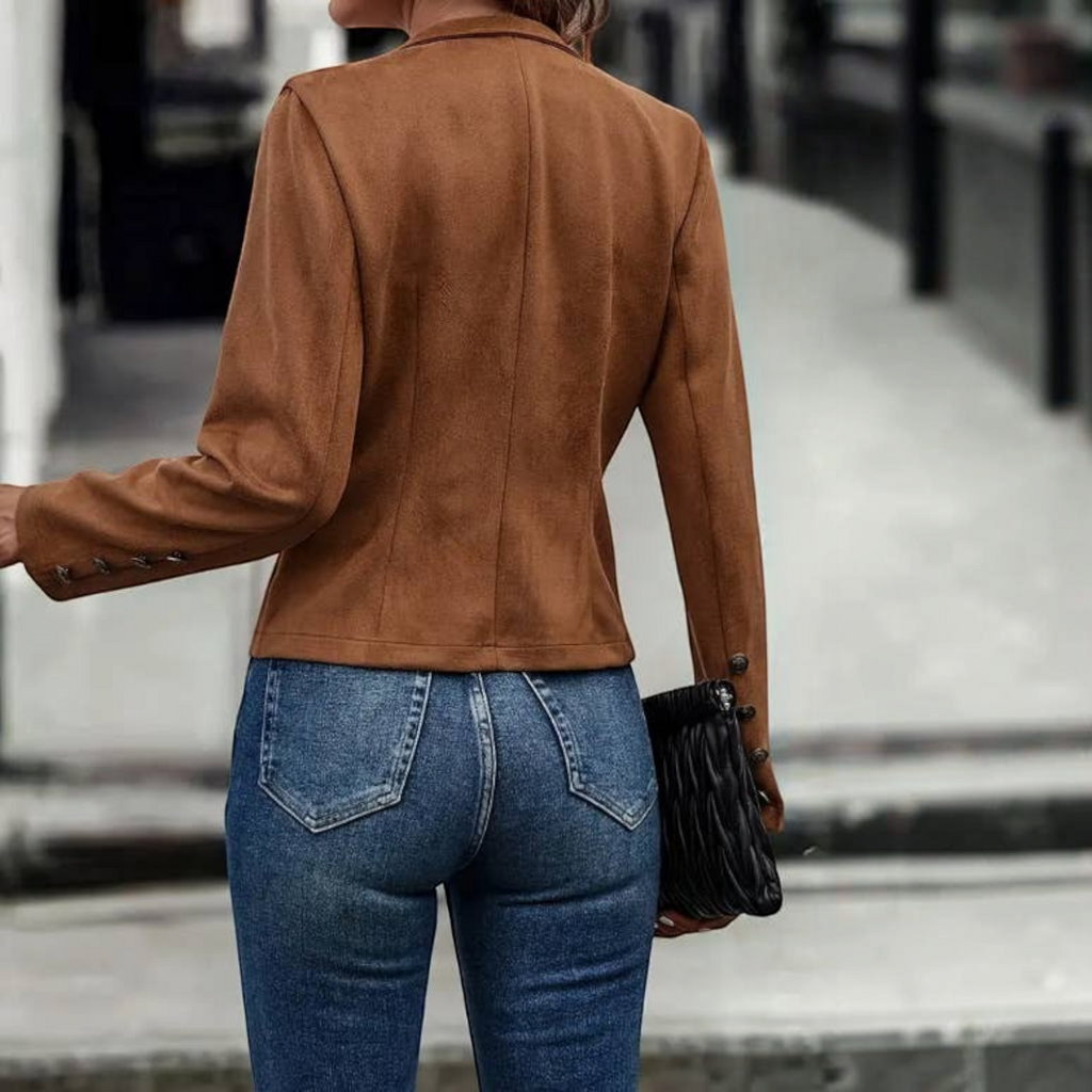 Angie Style Boutique brown velvet slim-fit jacket worn with blue jeans and a black clutch, back view