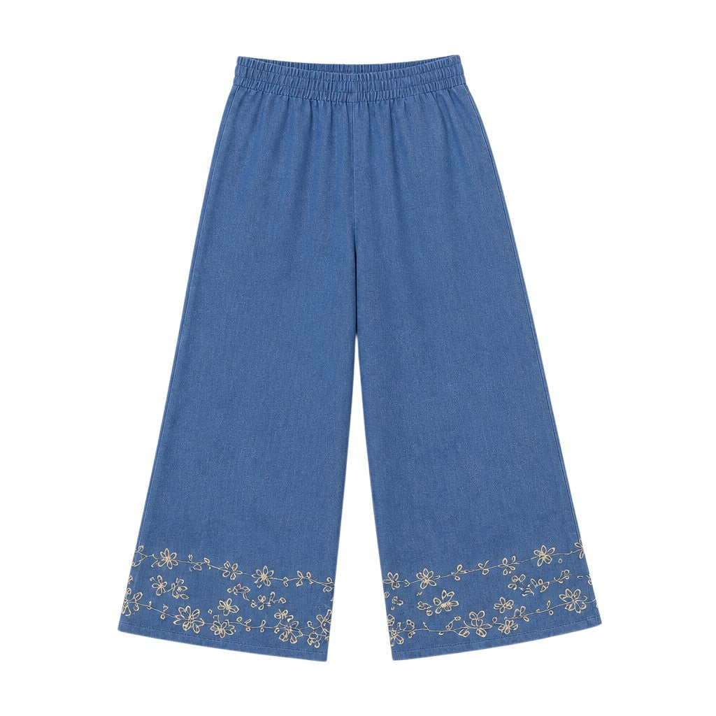 Angie Style Boutique blue chambray wide-leg pants with delicate floral embroidery at the hem and elastic waistband.