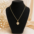 Angie Style Boutique gold heart pendant necklace with sparkling cubic zirconia stones on a black jewelry display bust