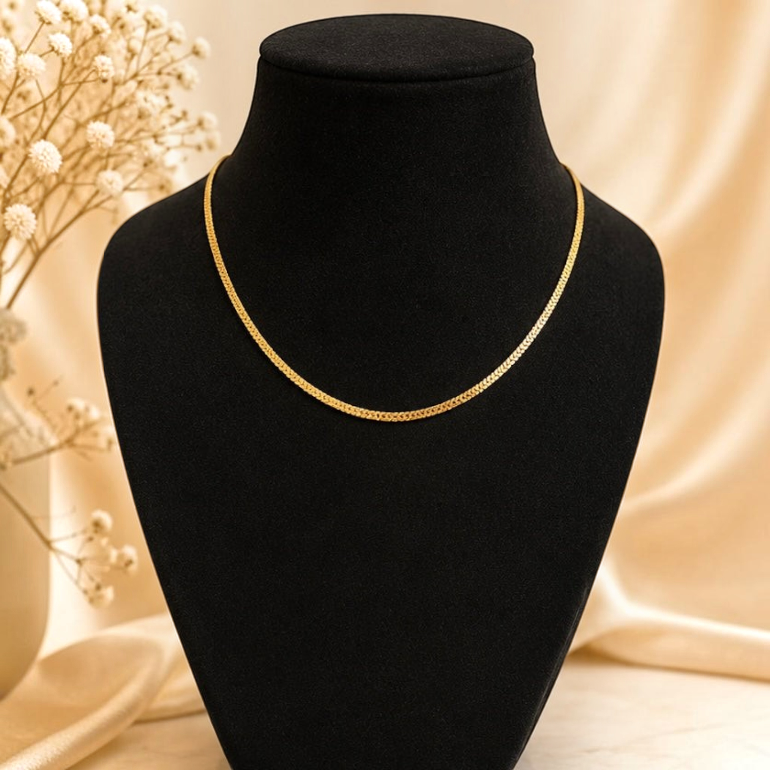 Angie Style Boutique gold-plated herringbone chain necklace on a black velvet display bust