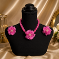 Angie Style Boutique hot pink floral beaded statement necklace and matching earring set on a black display bust.