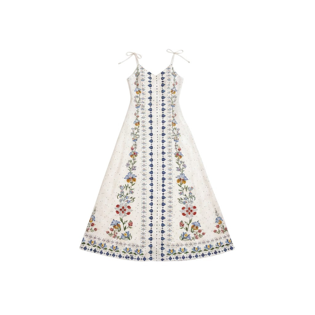 Angie Style Boutique white sleeveless maxi dress with blue and gold floral geometric trim and tie-strap shoulders.
